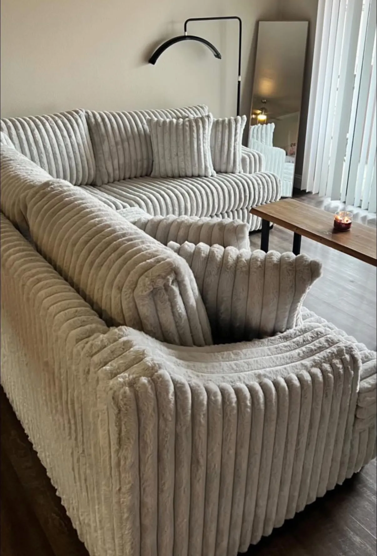 Custom cream plush channel sectional styled by the windows