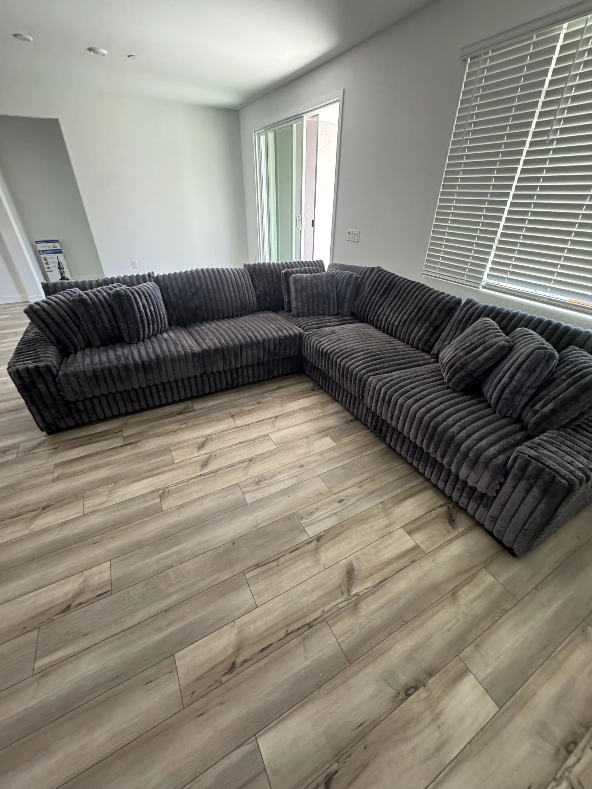 Black plush sectional set up in a new home